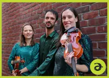 The three Fitzgerald siblings, one brother and two sisters, holding violins
