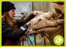 A young woman working on a sculpture