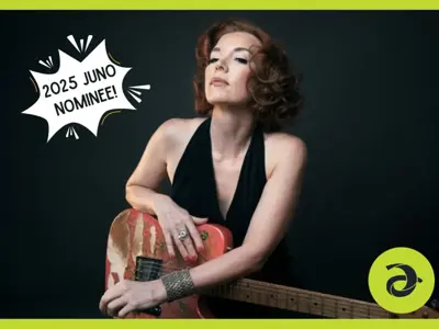 Woman in a black dress holding a guitar