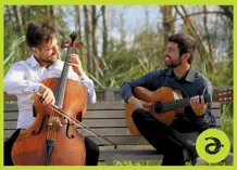 Ostiguy and Habib sitting on a park bench with their instruments