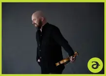 Mark Fewer holding a violin